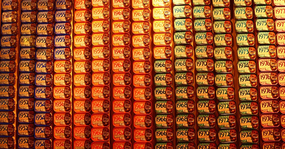 Vibrant display of sardine cans with various years, creating a vintage aesthetic.